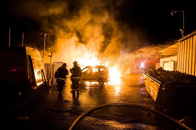 Israeli firefighters work at the scene where a rocket fired from the Gaza Strip hit in Sderot, Israel, Monday, Nov. 12, 2018. Israel's military says it is prepared to step up its efforts against Palestinian militants in the Gaza Strip if rocket fire at Israel continues. (AP Photo/Tsafrir Abayov)