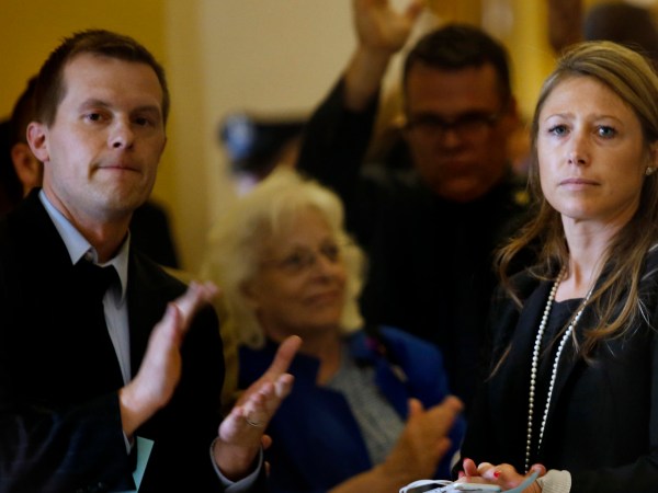 AUGUSTA, ME - JULY 1: House Majority Leader Erin Herbig and House Assistant Majority Leader Jared Golden, left, are met by applause at the State House by dozens of state workers on Saturday, July 1, 2017, the first day of Maine’s government shutdown following a a budget impasse that has yet to be resolved. (Staff photo by Derek Davis/Staff Photographer)