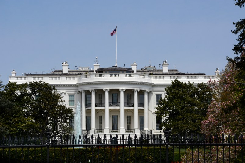 WASHINGTON, D.C. - APRIL 22, 2018:  An American flag flies over the south facade of the White House in Washington, D.C. Additional security fences and barriers were added along the south perimeter to prevent people from jumping the fence and entering the restricted White House grounds. The Secret Service tightened the security on the south side in 2017 by closing access to the entire fence line on the South Lawn. (Photo by Robert Alexander/Getty Images)