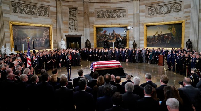 The flag-draped casket of former President George H.W. Bush lies in state in the Capitol Rotunda in Washington, Monday, Dec. 3, 2018. (AP Photo/Pablo Martinez Monsivais/Pool)