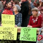 Protesters Peppi Elder, left, and Christine Taylor during the lighting of the 2018 State Capitol Christmas Tree in the Wisconsin State Capitol Rotunda. The Senate and Assembly are set to send dozens of changes in state law to Gov. Scott Walker’s desk Tuesday Dec. 4, 2018 at the Capitol in Madison. (AP Photo/Wisconsin State Journal, Steve Apps)