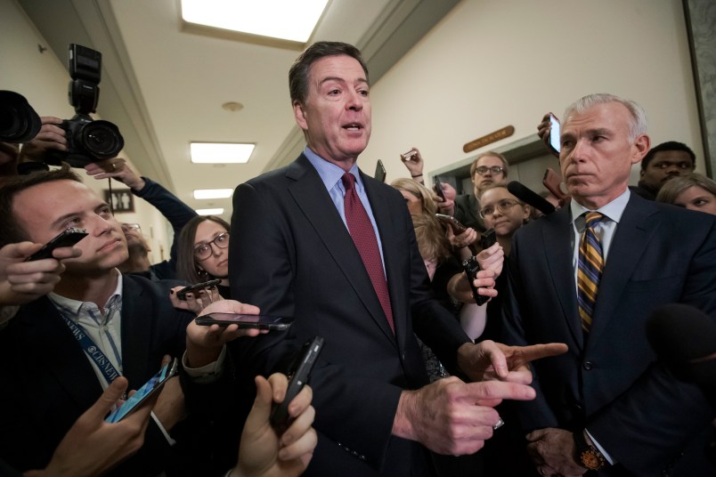 Former FBI Director James Comey, with his attorney, David Kelley, right, speaks to reporters after a day of testimony compelled by the GOP-led House Judiciary and Oversight committees, on Capitol Hill in Washington, Friday, Dec. 7, 2018.  (AP Photo/J. Scott Applewhite)