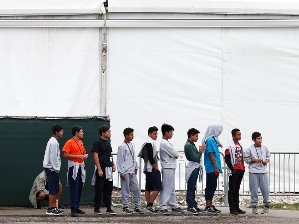 Immigrant boys walk in a line at the Homestead Temporary Shelter for Unaccompanied Children a former Job Corps site that now houses them Monday, Dec. 10, 2018, in Homestead, Fla. (AP Photo/Brynn Anderson)