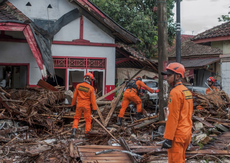Rescuers search for tsunami victims in Carita, Indonesia, Sunday, Dec. 23, 2018. The tsunami that killed dozens of people around Indonesia's Sunda Strait during a busy holiday weekend, sending water crashing ashore and sweeping away hotels, hundreds of houses and people attending a beach concert. (AP Photo/Fauzy Chaniago)