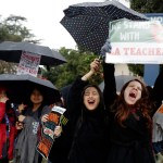 Maria Arienza, right, an English and Spanish teacher, shouts slogans alongside her student Stephanie Medrano, second from right, outside of North Hollywood High School Tuesday, Jan. 15, 2019, in Los Angeles. Teachers in the huge Los Angeles Unified School District walked picket lines again Tuesday as administrators urged them to return to classrooms and for their union to return to the bargaining table. (AP Photo/Marcio Jose Sanchez)