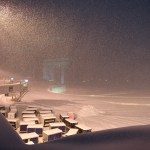 Airline baggage carts sit on the tarmac as crews prepare to move snow at the Albany International Airport in Colonie, N.Y., Sunday, Jan. 20, 2019. (AP Photo/Hans Pennink)