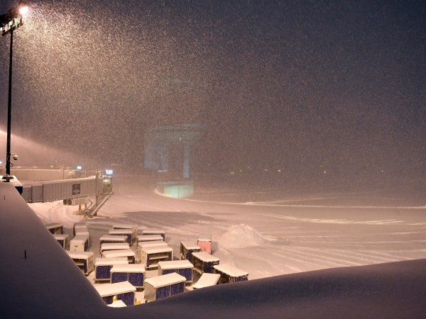 Airline baggage carts sit on the tarmac as crews prepare to move snow at the Albany International Airport in Colonie, N.Y., Sunday, Jan. 20, 2019. (AP Photo/Hans Pennink)
