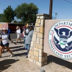 File-This June 2018, file photo shows protesters walking along Montana Avenue outside the El Paso Processing Center, in El Paso, Texas. Federal immigration officials are force feeding some of the dozens of Cuban and Indian immigrants who have been on hunger strike for nearly a month inside a Texas detention facility, The Associated Press has learned.  (Rudy Gutierrez/The El Paso Times via AP, File)