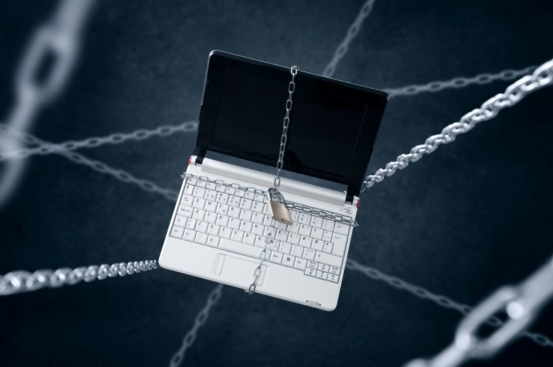 Chained laptop. Conception of sensitive data security.
