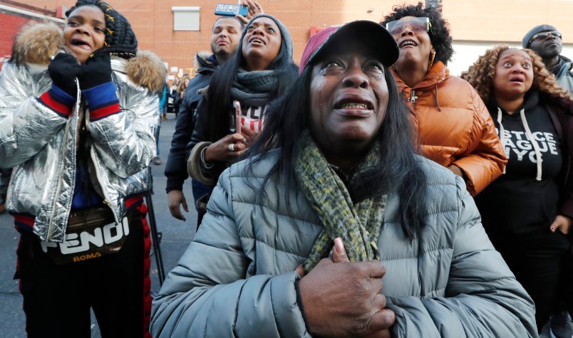 Cahana Yehudah, foreground, of the Bronx, cries as she hears the response of prisoners held inside the Metropolitan Detention Center, a federal facility with all security levels, Sunday, Feb. 3, 2019, in the Brooklyn borough of New York. The prison has been without heat, hot water, electricity and good sanitation for several days, including during the recent frigid weather. Yehudah has a brother who is serving 18 months at the prison for gun possession. (AP Photo/Kathy Willens)