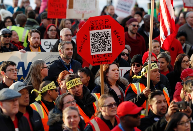 FILE - In this Jan. 30, 2019, file photo, Denver Public Schools teachers rally outside the State Capitol in Denver. Teachers plan to strike next week after Colorado officials declined to intervene in a pay dispute between the educators and the school district. State officials said Wednesday, Feb. 6, 2019, they believe the two sides are close to a negotiated agreement. Gov. Jared Polis said he expects the Denver Public Schools system and the union representing teachers to keep talking through the week to try to avoid a strike. (AP Photo/David Zalubowski, File)