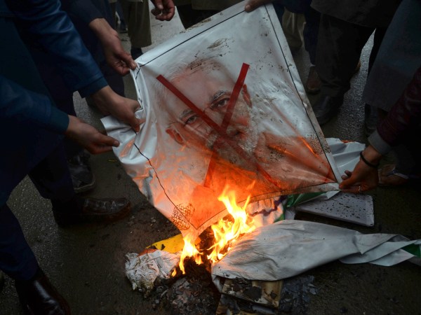 Pakistani protesters burn a poster of Indian Prime Minister Narendra Modi during an anti-Indian rally in Peshawar, Pakistan, Tuesday, Feb. 26, 2019. Pakistan said India launched an airstrike on its territory early Tuesday that caused no casualties, while India said it targeted a terrorist training camp in a pre-emptive strike that killed a "very large number" of militants. (AP Photo/Muhammad Sajjad)