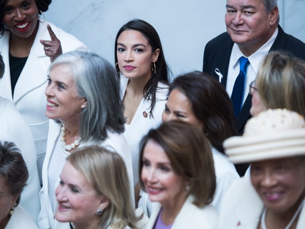 UNITED STATES - FEBRUARY 05: Rep. Alexandria Ocasio-Cortez, D-N.Y., top center, and Speaker Nancy Pelosi, D-Calif., bottom center, pose for a group photo of House Democrats in the Capitol Visitor Center, who plan to wear "suffragette white" to the State of the Union address to show solidarity for women's agendas on Tuesday, February 5, 2019. (Photo By Tom Williams/CQ Roll Call)