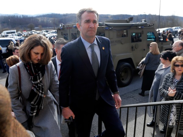 Virginia Gov. Ralph Northam, left,  and his wife Pam, left, leave the funeral of fallen Virginia State Trooper Lucas B. Dowell after the church service for the funeral at the Chilhowie Christian Church in Chilhowie, Va., Saturday, Feb. 9, 2019. Dowell was killed  in the line of duty earlier in the week. (AP Photo/POOL/Steve Helber)