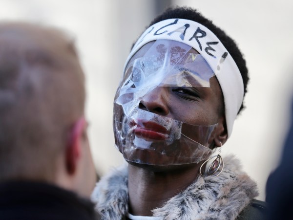 Therese Okoumou poses for pictures and rallies with supporters before her sentencing in New York, Tuesday, March 19, 2019. Okoumou was convicted of trespassing and other offenses after she climbed the base of the Statue of Liberty on July 4, 2018. (AP Photo/Seth Wenig)