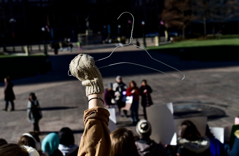 OHIO STATE HOUSE, COLUMBUS, OHIO, UNITED STATES - 2018/12/12: A protester seen holding a coat hanger which is an emblem of the pro-choice movement during a protest against the controversial Heartbeat Bill or HB258, which bans abortion once a fetal heartbeat is detected. The bill would make it much more difficult for women to seek an abortion in the state of Ohio. The bill was passed by members of the Ohio Senate with a vote of 18-13. Outgoing Ohio Governor John Kasich has said he would veto any such bill should it be passed by the Senate. (Photo by Matthew Hatcher/SOPA Images/LightRocket via Getty Images)