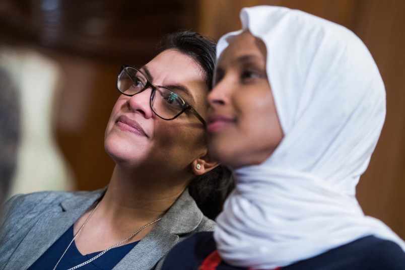 UNITED STATES - MARCH 13: Reps. Ilhan Omar, D-Minn., right, and Rashida Tlaib, D-Mich., attend a rally with Democrats in the Capitol to introduce the "Equality Act," which will amend existing civil rights legislation to bar discrimination based on gender identification and sexual orientation on Wednesday, March 13, 2019. (Photo By Tom Williams/CQ Roll Call)