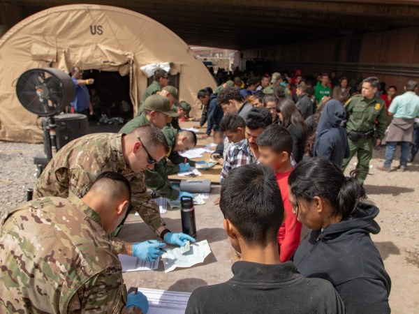 U.S. Border Patrol agents, including members of U.S. Border Patrol's BORSTAR teams (in tactical uniforms) provide food, water and medical screening to scores of migrants at a processing center after crossing the international border between the United States and Mexico in El Paso, Texas, March 22, 2019. Large groups of immigrants most often surrender to border patrol agents immediately after arriving on U.S. soil. U.S. Customs and Border Protection photo by Mani Albrecht