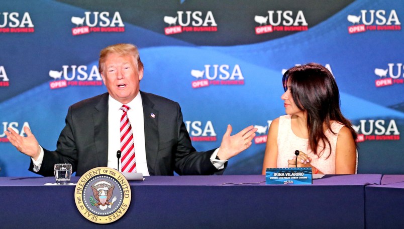 U.S. President Donald Trump, flanked by Maximo Alvarez and Irina Vilarino, talks at a Roundtable Discussion on Tax Reform on Monday, April 16, 2018 at Bucky Dent Park in Hialeah, Fla. (Charles Trainor Jr./Miami Herald/TNS)