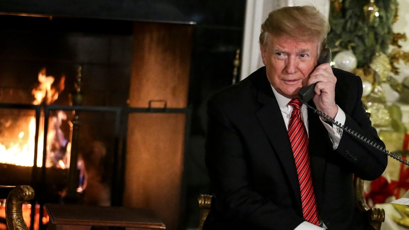 WASHINGTON, DC - DECEMBER 24: President Donald Trump and first lady Melania Trump speak on the phone with children as they track Santa Claus with the North American Aerospace Defense Command, NORAD, on Christmas Eve in the State Dinning Room of the White House on December 24, 2018 in Washington, DC.(Photo by Oliver Contreras/For The Washington Post)