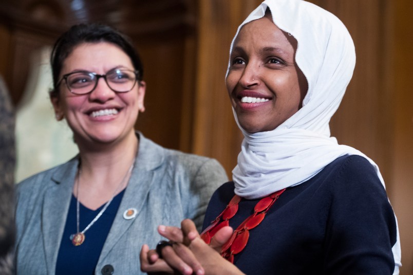 UNITED STATES - MARCH 13: Reps. Ilhan Omar, D-Minn., right, and Rashida Tlaib, D-Mich., attend a rally with Democrats in the Capitol to introduce the "Equality Act," which will amend existing civil rights legislation to bar discrimination based on gender identification and sexual orientation on Wednesday, March 13, 2019. (Photo By Tom Williams/CQ Roll Call)