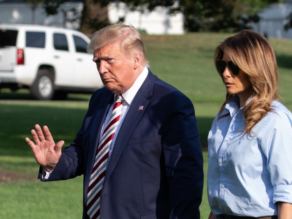 U.S. President Donald Trump waves with First Lady Melania Trump by his side as they walk on the South Lawn of the White House after arriving on Marine One in Washington, DC., on Sunday, August 4, 2019.  (Photo by Cheriss May/NurPhoto)