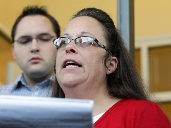 Rowan County Clerk Kim Davis, with son Nathan Davis, a deputy clerk, reads a statement to the press outside the Rowan County Courthouse on Sept. 14, 2015 in Morehead, Ky. Davis did not interfere with marriage licenses issued after she returned to work. (Pablo Alcala/Lexington Herald-Leader/TNS)