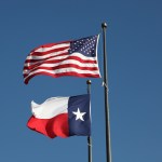 American flag and Texas flag flying at the  LBJ Library in Austin.