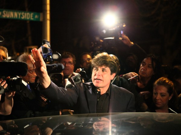 Former Gov. Rod Blagojevich waves to the crowd in front of his home as he leaves for prison, Thursday, March 15, 2012 in Chicago. Blagojevich is resentencing today. (William DeShazer/Chicago Tribune/TNS)