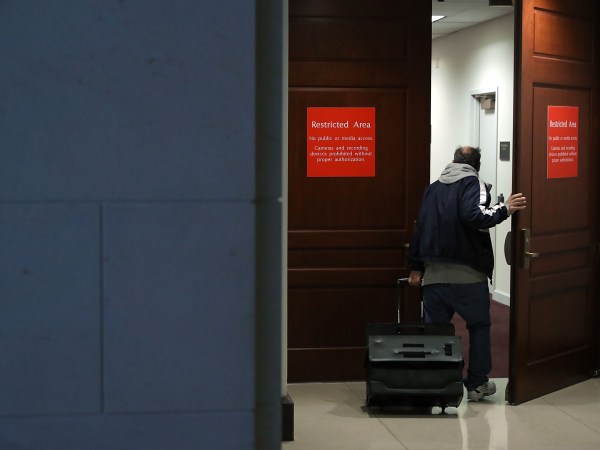 A person leaving the secure offices of the House Intelligence Committee bolts upstairs after a six-page memo alleging misconduct by senior FBI officials investigating President Donald Trump's 2016 campaign was released to the public February 2, 2018 in Washington, DC. Assembled by Committee staff of House Intelligence Committee Chairman Devin Nunes (R-CA), the formerly classified memo alleging FBI misconduct was released to the public Friday with permission from President Donald Trump.