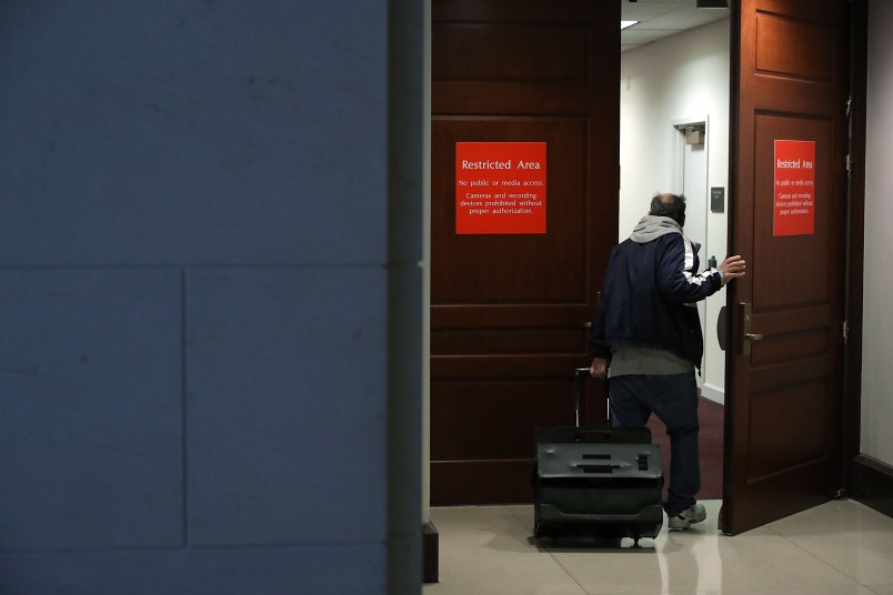 A person leaving the secure offices of the House Intelligence Committee bolts upstairs after a six-page memo alleging misconduct by senior FBI officials investigating President Donald Trump's 2016 campaign was released to the public February 2, 2018 in Washington, DC. Assembled by Committee staff of House Intelligence Committee Chairman Devin Nunes (R-CA), the formerly classified memo alleging FBI misconduct was released to the public Friday with permission from President Donald Trump.