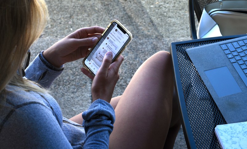 JACKSONVILLE, OREGON - JUNE 19, 2019: A young woman uses her smartphone as she sits outside a coffee shop in Jacksonville, Oregon. (Photo by Robert Alexander/Getty Images)