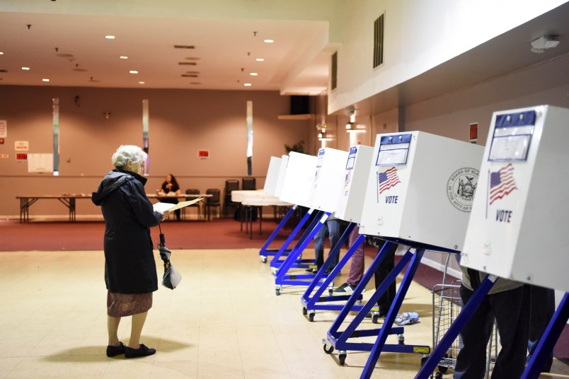 NEW YORK, Nov. 7, 2018 -- A voter walks to the booth to fill in her ballot at a polling station in Staten Island of New York Nov. 6, 2018. The U.S. Republican Party on Tuesday managed to maintain a Senate majority in the midterm elections, while the Democrats wrestled the House majority from the Republicans, according to projections of multiple news outlets. (Xinhua/Han Fang)