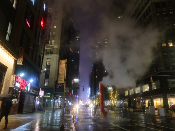 NEW YORK , NY - DEC 11: People walk along Broadway in the rain before sunrise on December 11, 2019, in New York City. (Photo by Gary Hershorn/Getty Images)