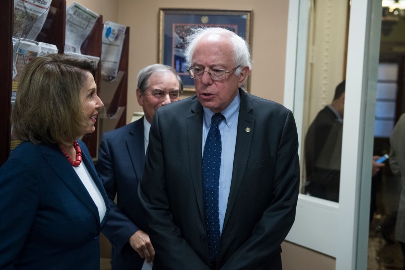 UNITED STATES - OCTOBER 04: From left, House Minority Leader Nancy Pelosi, D-Calif., Rep. John Yarmuth, D-Ky., and Sen. Bernie Sanders, I-Vt., prepare for a news conference in the Capitol to speak out against Republicans' tax and budget plan that they say will benefit the wealthy on October 4, 2017. (Photo By Tom Williams/CQ Roll Call)