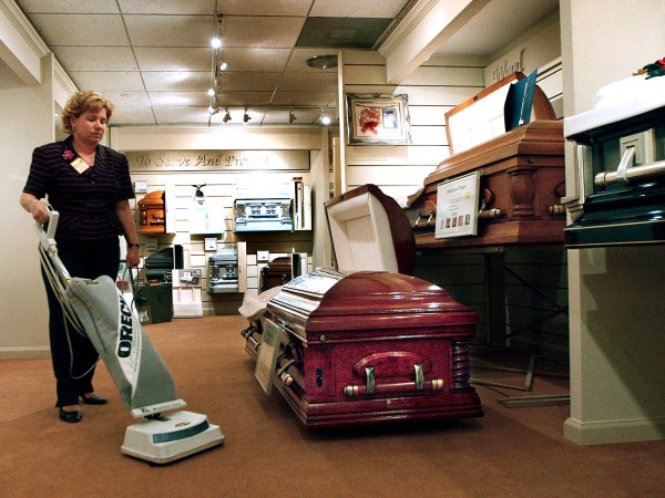 Patricia Jo Ralph, funeral director at T.M. Ralph Funeral Homes in Plantation, Florida, vacuums around a casket, April 3, 2009. The funeral industry is suffering in the recession as people choose cheaper services or cremation. Some funeral homes are cutting costs by doing things themselves. (Lilly Echeverria/Miami Herald/MCT)