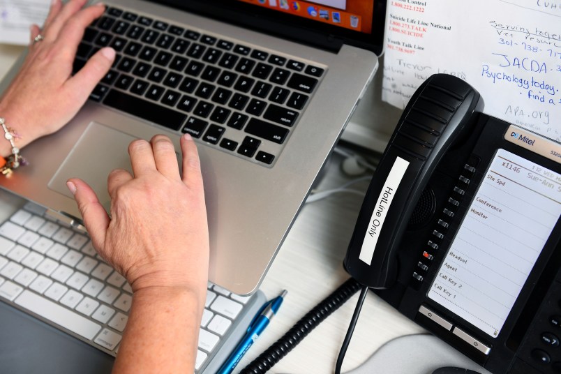 CHEVY CHASE, MD - MARCH 18:Sue-Ann Siegel logs in a summary of a call to the Montgomery County Hotline from her home office March 18, 2020 in Chevy Chase, MD. The covid-19 pandemic has led to a big spike in calls to mental health and suicide prevention hotlines. (Photo by Katherine Frey/The Washington Post)