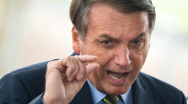 BRASILIA, BRAZIL - MARCH 25: Brazilian President Jair Bolsonaro speaks with press at the official residence during the coronavirus  (COVID - 19) pandemic at the Palacio do Alvorada March, 25, 2020 in Brasilia, Brazil. President Bolsonaro recently defended the nation's return to normality and the end of social distancing and quarantine. (Photo by Andressa Anholete / Getty Images)