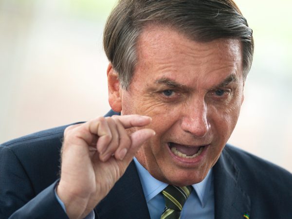 BRASILIA, BRAZIL - MARCH 25: Brazilian President Jair Bolsonaro speaks with press at the official residence during the coronavirus  (COVID - 19) pandemic at the Palacio do Alvorada March, 25, 2020 in Brasilia, Brazil. President Bolsonaro recently defended the nation's return to normality and the end of social distancing and quarantine. (Photo by Andressa Anholete / Getty Images)