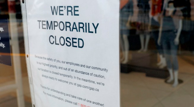A  GAP store with a Closed sign due to the COVID-19 outbreak in Farmington Hills, Michigan, on March 26, 2020. - The economic shutdown caused by the coronavirus pandemic sparked an explosion of Americans filing for unemployment benefits, surging to 3.3 million last week -- the highest number ever recorded, the Labor Department reported Thursday. (Photo by JEFF KOWALSKY / AFP) (Photo by JEFF KOWALSKY/AFP via Getty Images)