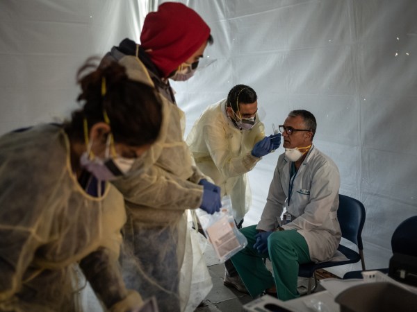 NEW YORK, NY - MARCH 24:  Doctors test hospital staff with flu-like symptoms for COVID-19. St. Barnabas hospital in the Bronx set-up tents to triage possible COVID-19 patients outside before they enter the main Emergency department area on March 24, 2020 in New York City. (Photo by Misha Friedman/Getty Images)