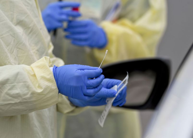 A detail photo of a nasal swab held by a Registered Nurse wearing gloves and a protective gown that she is about to use to do a test on a patient in their car at Penn State Health St. Joseph where they are conducting drive through coronavirus / COVID-19 testing and have taken extra precautions regarding entry to the hospital,  in Bern Township, PA Friday afternoon March 27, 2020.