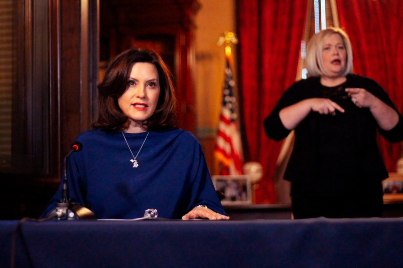 In a pool photo provided by the Michigan Office of the Governor, Gov. Gretchen Whitmer addresses the state during a speech in Lansing, Mich., Monday, March 30, 2020. The governor said she suspended state hiring and promotions and vetoed $80 million in new spending in order to steer money to fighting the coronavirus. At the same time, Whitmer said she signed laws with $150 million for the state's response. She said it's too early to know how the economic slowdown related to the virus will affect state revenue but the impact "is going to be real.” (Michigan Office of the Governor via AP, Pool)