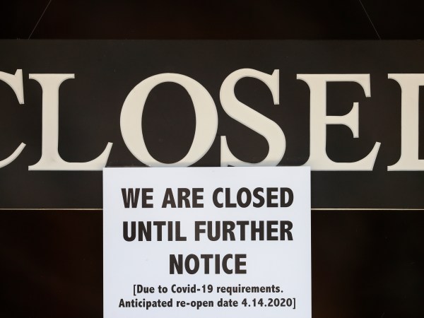 A notice of closure is posted at The Great Frame Up in Grosse Pointe Woods, Mich., Thursday, April 2, 2020. The coronavirus COVID-19 outbreak has triggered a stunning collapse in the U.S. workforce with 10 million people losing their jobs in the past two weeks and economists warn unemployment could reach levels not seen since the Depression, as the economic damage from the crisis piles up around the world. (AP Photo/Paul Sancya)