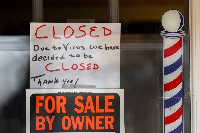 A For Sale By Owner and closed due virus sign are shown at Images On Mack in Grosse Pointe Woods, Mich., Thursday, April 2, 2020. The coronavirus COVID-19 outbreak has triggered a stunning collapse in the U.S. workforce with 10 million people losing their jobs in the past two weeks and economists warn unemployment could reach levels not seen since the Depression, as the economic damage from the crisis piles up around the world. (AP Photo/Paul Sancya)