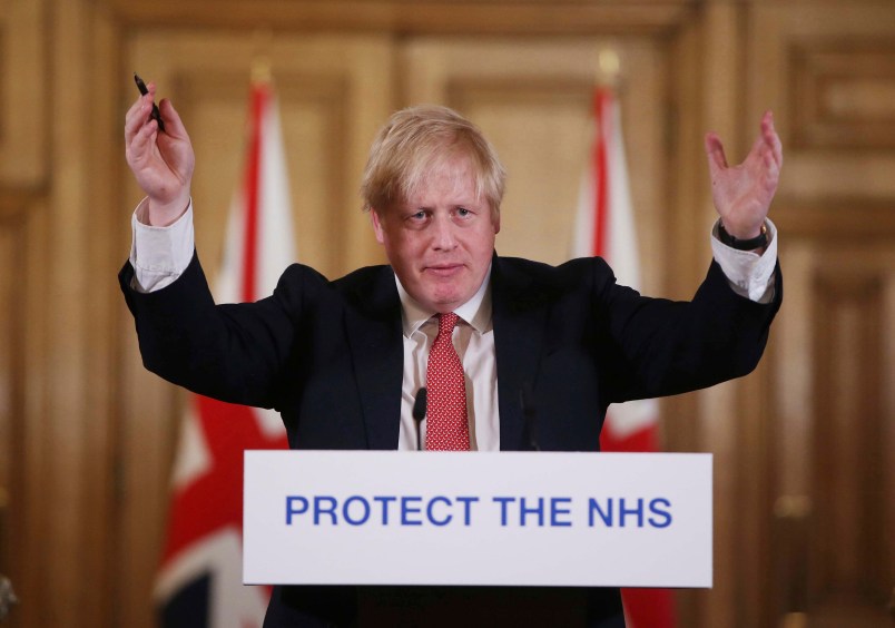 FILE - In this Sunday March 22, 2020 file photo British Prime Minister Boris Johnson gestures during his daily COVID 19 coronavirus press briefing to announce new measures to limit the spread of the virus, at Downing Street in London.  The British prime minister’s office says Boris Johnson will return to work Monday April 27, 2020, two weeks after he was discharged from a London hospital where he was treated for the new coronavirus. (Ian Vogler / Pool via AP, File)