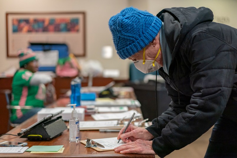 CHICAGO, IL - MARCH 17: Richard Rudberg casts ballots on Illinois' primary election day despite the COVID-19 pandemic in Chicago on March 17, 2020. (Photo by Youngrae Kim for The Washington Post)