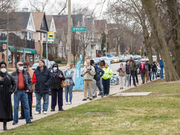 Milwaukee, WI - APRIL 7th: A line to vote in Wisconsin’s spring primary election wraps around for blocks and blocks on Tuesday April 7th, 2020 at Riverside High School in Milwaukee, WI. (Photo by Sara Stathas for the Washington Post)