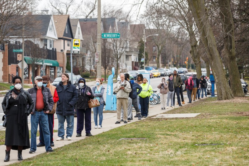 Milwaukee, WI - APRIL 7th: A line to vote in Wisconsin’s spring primary election wraps around for blocks and blocks on Tuesday April 7th, 2020 at Riverside High School in Milwaukee, WI. (Photo by Sara Stathas for the Washington Post)