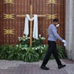 An unidentified man passes the closed front doors of St. Mary's Cathedral as houses of worship closed their doors, but telecast their Sunday Easter services via social media, as large social and religious gatherings are prohibited due to shelter-in-place mandates by local and state governments on Easter Sunday, April 12, 2020 in Miami, Fla. (Carl Juste/Miami Herald/TNS)